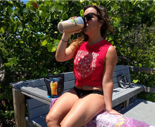 Woman drinking CHIKE outdoors